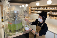 Load image into Gallery viewer, PARU Founder Amy Truong milling matcha at PARU La Jolla