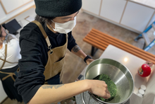 Load image into Gallery viewer, PARU Founder Amy Truong milling matcha at PARU La Jolla